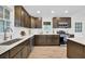 Well-lit kitchen showcases granite countertops, stainless steel appliances, and dark wood cabinets at 6470 Windsor Dr, Acworth, GA 30102