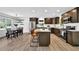 Modern kitchen features stainless steel appliances, wood cabinets, granite counters, and dining area at 6470 Windsor Dr, Acworth, GA 30102