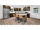 A modern kitchen with stainless appliances, an island with seating, and dark cabinets at 6470 Windsor Dr, Acworth, GA 30102