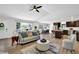 A living room featuring hardwood floors, modern decor, vaulted ceilings, and a kitchen in the background at 6470 Windsor Dr, Acworth, GA 30102