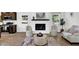 The living room showcases a brick fireplace, neutral armchairs, and wood floors adjacent to the kitchen at 6470 Windsor Dr, Acworth, GA 30102