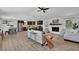 This bright, open-concept living room showcases a modern design, fireplace, and seamless flow into the adjacent kitchen and dining area at 6470 Windsor Dr, Acworth, GA 30102