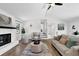 Bright living room features a brick fireplace, modern decor, hardwood flooring, and open space at 6470 Windsor Dr, Acworth, GA 30102