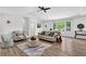 A naturally lit living room featuring a vaulted ceiling, fireplace and hardwood flooring throughout at 6470 Windsor Dr, Acworth, GA 30102