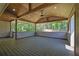 Relaxing covered patio with ceiling fan and wood flooring provides a great outdoor living space at 6470 Windsor Dr, Acworth, GA 30102