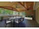 Covered patio with wood ceiling, ceiling fan, outdoor dining furniture, and exterior view at 6470 Windsor Dr, Acworth, GA 30102