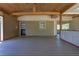 This covered patio is perfect for relaxing, featuring wood floors and walls with backyard access at 6470 Windsor Dr, Acworth, GA 30102