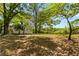 Spacious backyard with mature trees and room for outdoor activities and landscaping at 1825 Sw Willis Mill Rd, Atlanta, GA 30311
