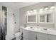 Bathroom features a double sink vanity and tiled shower with a glass accent panel at 1825 Sw Willis Mill Rd, Atlanta, GA 30311