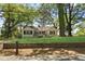 Charming home with a lush front yard, a quaint porch and a classic stone retaining wall at 1825 Sw Willis Mill Rd, Atlanta, GA 30311