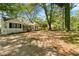 Charming ranch-style house with a lush, tree-filled front yard at 1825 Sw Willis Mill Rd, Atlanta, GA 30311