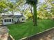 Beautifully maintained one-story home with a lush green front yard and mature trees at 1825 Sw Willis Mill Rd, Atlanta, GA 30311