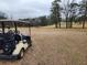 Image of a golf cart parked by the fairway, with the green and surrounding trees in the background at 1825 Sw Willis Mill Rd, Atlanta, GA 30311