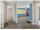 Open-concept living room with blue walls that opens to a hallway and bedroom at 1825 Sw Willis Mill Rd, Atlanta, GA 30311