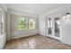 Bright sun room with white painted brick and tile flooring at 1825 Sw Willis Mill Rd, Atlanta, GA 30311