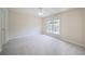 Bedroom with neutral walls, carpeted floors and a view of the neighborhood at 4205 Royal Regency Nw Cir, Kennesaw, GA 30144