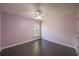 This is a bedroom with dark laminate flooring and a ceiling fan at 4205 Royal Regency Nw Cir, Kennesaw, GA 30144