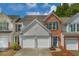 Charming townhome featuring a combination of brick and siding and a two-car garage at 4205 Royal Regency Nw Cir, Kennesaw, GA 30144