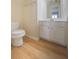 Cozy half bathroom featuring hardwood floors and a white vanity at 4205 Royal Regency Nw Cir, Kennesaw, GA 30144