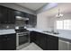 Modern kitchen featuring stainless steel appliances and tiled backsplash at 4205 Royal Regency Nw Cir, Kennesaw, GA 30144
