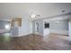 Spacious living area featuring hard floors and view of the staircase and kitchen at 4205 Royal Regency Nw Cir, Kennesaw, GA 30144