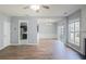 Bright living room with wood floors, view into dining and kitchen spaces at 4205 Royal Regency Nw Cir, Kennesaw, GA 30144