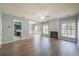 Open-concept living room with fireplace, wood flooring and large windows at 4205 Royal Regency Nw Cir, Kennesaw, GA 30144