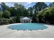 Community pool with a winter cover and pool house in the background at 4205 Royal Regency Nw Cir, Kennesaw, GA 30144