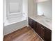 Bathroom features a soaking tub, double sinks with wood cabinets, and modern fixtures at 4452 Belcamp Rd, Fairburn, GA 30213