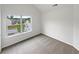 Well-lit bedroom features neutral carpet and a large window with neighborhood views at 4452 Belcamp Rd, Fairburn, GA 30213