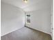 Comfortable bedroom featuring neutral carpet and a window with neighborhood views at 4452 Belcamp Rd, Fairburn, GA 30213