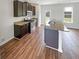 Well-lit kitchen features dark cabinets, stainless steel appliances, and a functional center island at 4452 Belcamp Rd, Fairburn, GA 30213