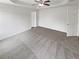 Spacious primary bedroom with tray ceilings and plush carpeting, perfect for relaxation at 4452 Belcamp Rd, Fairburn, GA 30213