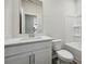 Clean bathroom featuring white cabinets, solid surface vanity, and shower-tub combo with white enclosure at 173 Soseby Lake Ln, Grayson, GA 30017