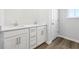 Bathroom with double sinks and wood-look vinyl floors at 173 Soseby Lake Ln, Grayson, GA 30017