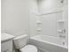 Clean bathroom featuring white cabinets, solid surface vanity, and shower-tub combo with white enclosure at 173 Soseby Lake Ln, Grayson, GA 30017