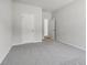 Neutral bedroom featuring gray carpet, bright white walls, and bright doors at 173 Soseby Lake Ln, Grayson, GA 30017