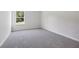 Cozy bedroom features neutral paint, one large window, and plush carpeting at 173 Soseby Lake Ln, Grayson, GA 30017