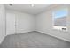Neutral bedroom featuring gray carpet, bright white walls, and a bright window at 173 Soseby Lake Ln, Grayson, GA 30017