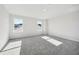 Large bedroom featuring neutral paint, two large windows, and plush carpeting at 173 Soseby Lake Ln, Grayson, GA 30017