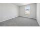 Bedroom with neutral walls, carpet, and a backyard view at 173 Soseby Lake Ln, Grayson, GA 30017