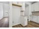 Bright kitchen features white cabinets, stainless steel hardware, granite countertops, and wood-look flooring at 173 Soseby Lake Ln, Grayson, GA 30017