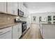 Well-lit kitchen with stainless steel appliances, granite countertops, modern cabinetry, and backsplash tiling at 173 Soseby Lake Ln, Grayson, GA 30017