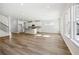 Bright and airy open floor plan with modern kitchen, island seating, and large windows showcasing outdoor views at 173 Soseby Lake Ln, Grayson, GA 30017