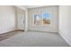 Well-lit living room features two windows, neutral paint, and plush carpeting at 173 Soseby Lake Ln, Grayson, GA 30017