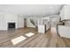 Bright, open-concept living space with fireplace, flowing into a modern kitchen with an island and stainless appliances at 173 Soseby Lake Ln, Grayson, GA 30017