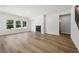 Expansive living room with abundant light, a cozy fireplace, and stairway, ideal for gatherings at 173 Soseby Lake Ln, Grayson, GA 30017
