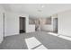 Spacious loft area features neutral paint, carpeted floor, and access to additional rooms at 173 Soseby Lake Ln, Grayson, GA 30017