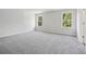 Large carpeted bedroom filled with natural light from two windows, inviting tranquility at 361 Tallulah Ln, Grayson, GA 30017