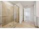 Bathroom showcasing a glass-enclosed shower with tile surround, and wood-look flooring at 366 Tallulah Ln, Grayson, GA 30017